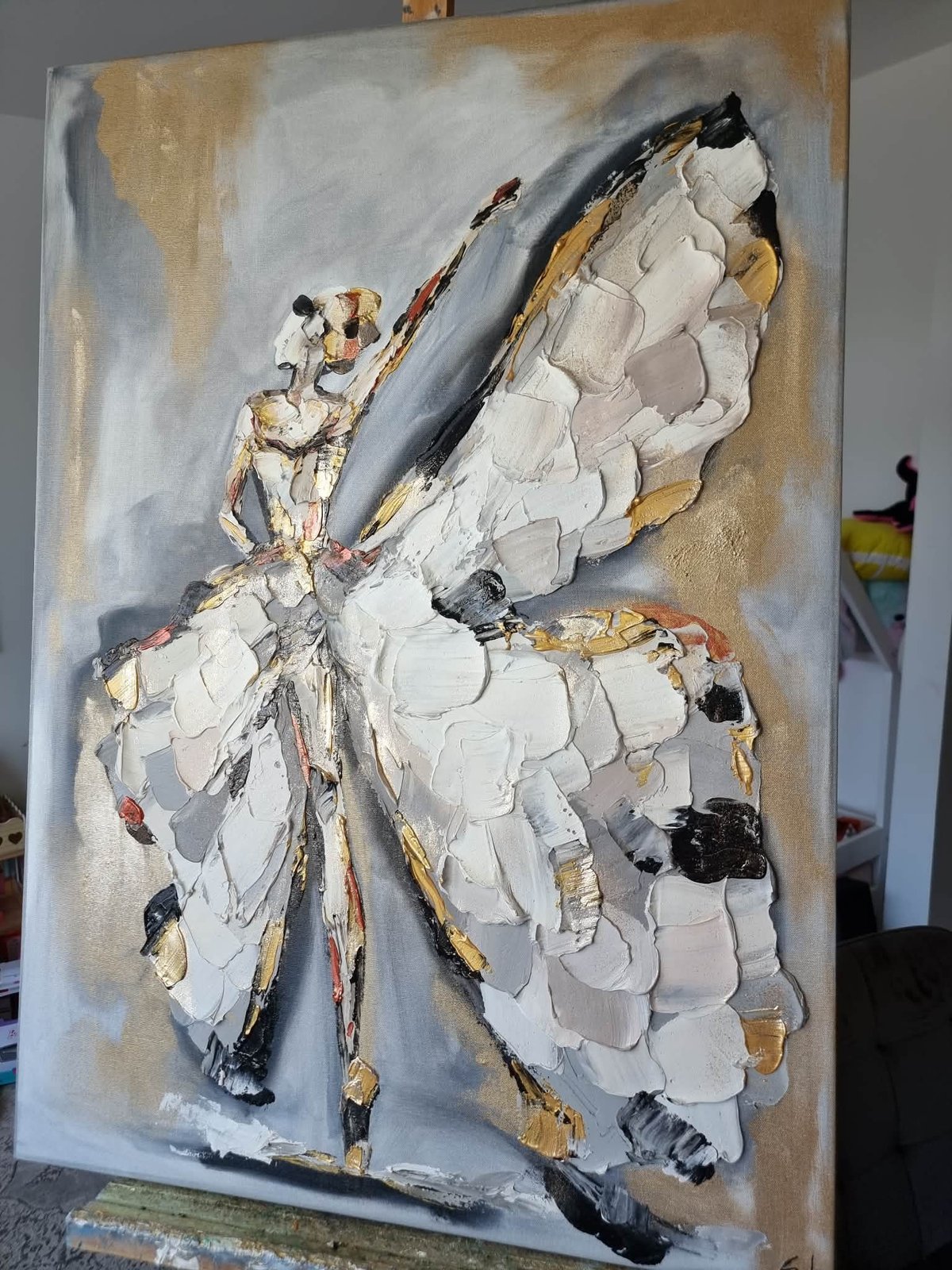Textured oil painting of a white and gold butterfly with black accents on a neutral background